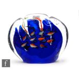 A Murano aquarium block of scalloped form, with a school of tropical fish swimming amongst reeds,