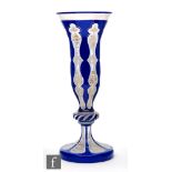 A late 19th Century Bohemian vase of trumpet form, raised to a knopped stem above a domed foot,