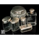 Six hallmarked silver and clear glass dressing table jars to include powder, cologne and other