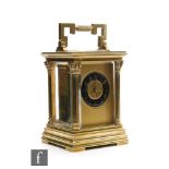 A 19th Century French brass carriage clock, blue enamelled circular Arabic dial in Corinthian column