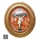 An early 20th Century gilt oval framed and convex glazed study of the crucifixion, labelled '