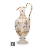 A late 19th Century opaline glass jug of footed baluster form with quatrefoil rim, decorated with