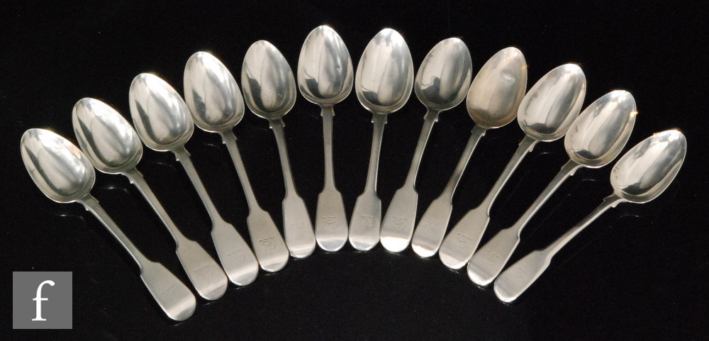 Twelve hallmarked silver George III and later fiddle pattern dessert spoons, total weight 18.5oz,