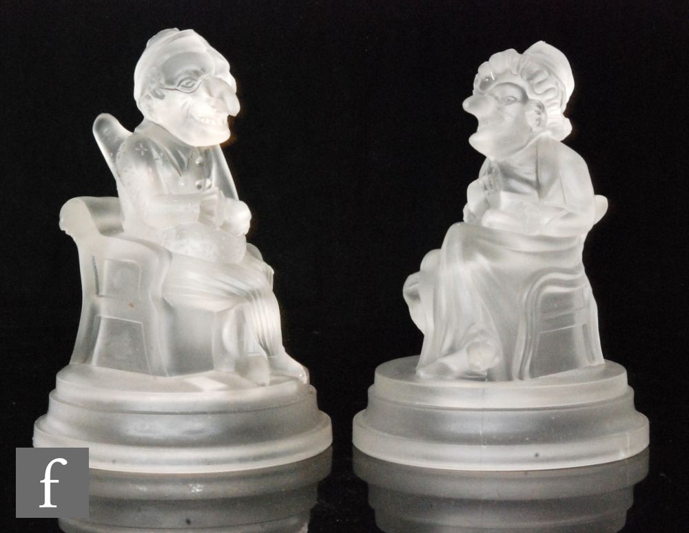 A pair of late 19th Century novelty Mr Punch & Judy figures by John Derbyshire, both figures seated,