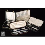 Four cased sets of flatware to include two knife, fork and spoon sets, a pusher set and a further