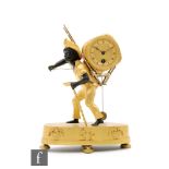 A French Empire ormolu and patinated bronze figural mantel clock, modelled as a man carrying a