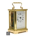 A 20th Century French brass carriage clock by T.N Hill & Son, Morton-In-Marsh, on bracket plinth,