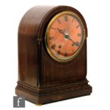 An early 20th Century mahogany eight day strike arch top mantle clock, Roman numerals to a copper