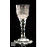 An 18th Century drinking glass circa 1780, round funnel bowl engraved with a floral spray and exotic