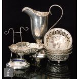 A hallmarked silver helmet cream jug with a set of four circular bon bon dishes and a similar oval