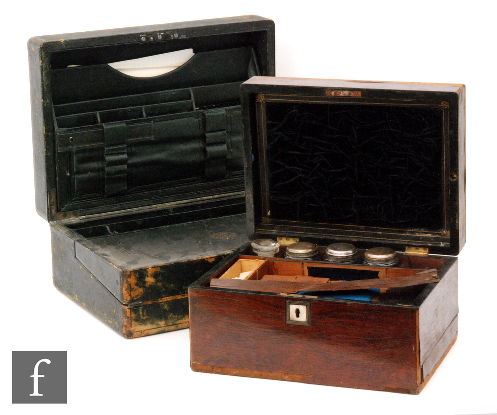 A Victorian leather writing box opening to reveal a fall front slope and fitted interior