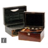 A Victorian leather writing box opening to reveal a fall front slope and fitted interior