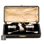 A cased hallmarked silver three piece, boat shaped, cruet set each raised on four pad feet,