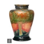 William Moorcroft - A small vase of inverted baluster form decorated in the Eventide pattern with