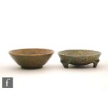 Ruskin Pottery - Two footed bowls, the first raised to three angular feet and decorated in a dark