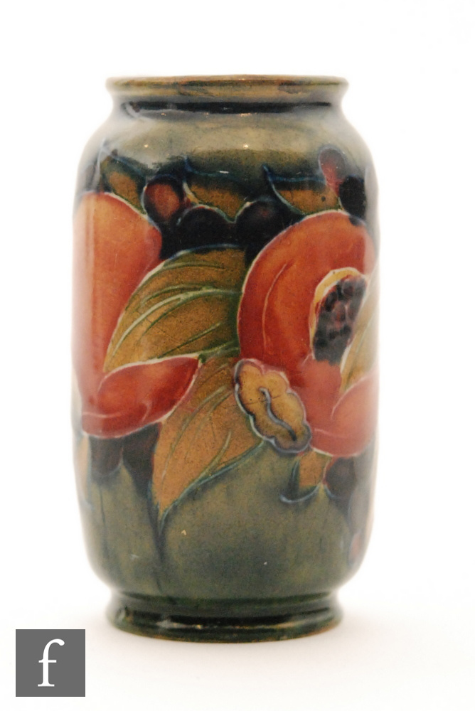 William Moorcroft - A small barrel form vase decorated in the Pomegranate pattern with a band of