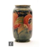 William Moorcroft - A small barrel form vase decorated in the Pomegranate pattern with a band of