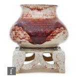 Ruskin Pottery - A high fired vase and stand, the vase of swollen form with a flared collar neck