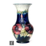 William Moorcroft - A baluster form vase decorated in the Pansy pattern with tubelined flowers and