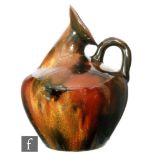 Christopher Dresser - Linthorpe - A late 19th Century jug of bulbous form with a loop handle and