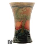 William Moorcroft - A small vase of waisted flared from decorated in the Eventide pattern with a