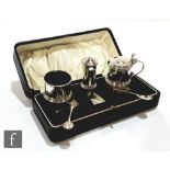 A cased hallmarked silver three piece drum shaped condiment set of plain form, Birmingham 1926,