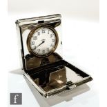 A hallmarked silver folding travel clock, the square case with engine turned decoration opening to