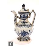 A Chinese blue and white wine pot of baluster form rising from a splayed base, decorated with