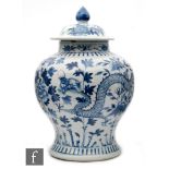 A Chinese blue and white Kangxi style meiping vase with domed cover with pointed finial, decorated