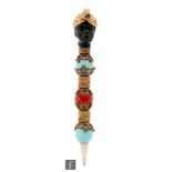 A late 19th and early 20th Century propelling pencil modelled as a black head wearing a gilt turban,