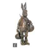 A 20th Century bronze desk stand modeled as Brer Rabbit holding a French horn, suited and holding