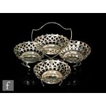 A hallmarked silver table centre piece with four pierced circular bon bon dishes to a plain stand