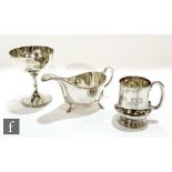 Three items of hallmarked silver to include a sauce boat, a small goblet and a christening cup,