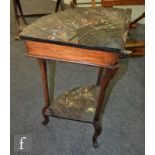 A 1920s two tier corner table embossed with Japanese design of fan shape depicting a figure by a