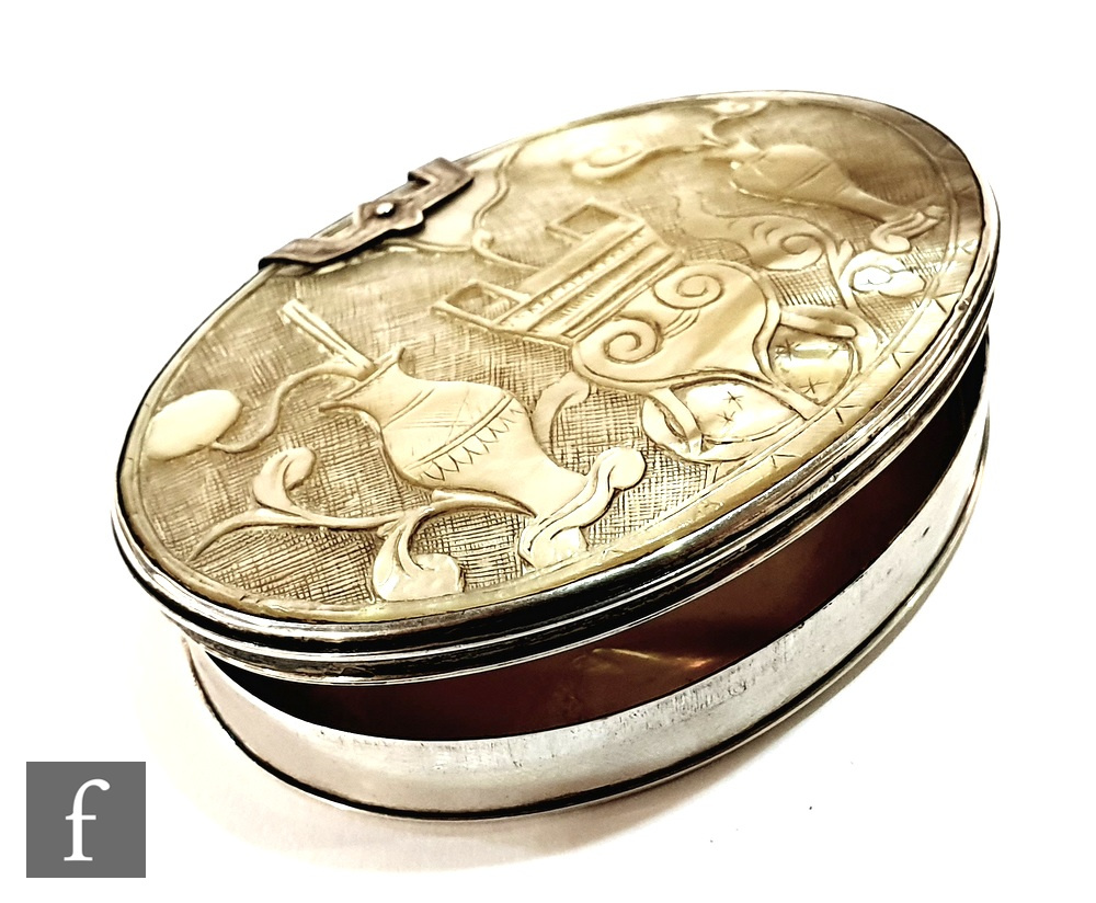 An early 19th century hinged lid silver and carved abalone snuff box of oval form, width 7cm.