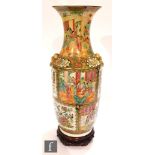A 19th Century Chinese Canton famille rose vase of baluster form the body applied with shishi mask