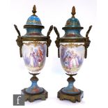 A pair of 19th Century continental Sevres style vases of urn form with covers and gilt metal mounts,