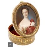 A late 19th and early 20th Century French gilt oval box painted with a portrait of a lady wearing