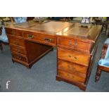 A George III style mahogany partners desk, the tooled leather top over three frieze drawers and