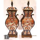 A pair of Imari style porcelain table lamps, each of baluster form, applied with gilt metal acanthus