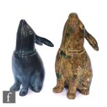 Two 20th Century Japanese cast metal figures of rabbits, each in a seated position with head raised,