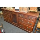 A 19th Century pine dresser base, the central cupboard flanked by three drawers to each side,