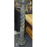 A 20th Century green serpentine stone pedestal, the circular top above a spiral column on