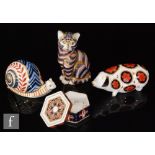 A collection of three Royal Crown Derby paperweights comprising a pig, a cat and a snail together