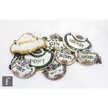 Seven assorted 19th Century and later decanter labels with an enamelled example to include three