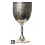 A Victorian hallmarked silver goblet with part engraved foliate decoration above bright cut spread