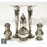 Five items of silver to include a pair of trumpet vases, a sugar castor and two Georgian castors,
