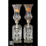 A pair of large 19th Century clear crystal table lustres with a radial cut petal edge foot beneath a