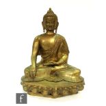 A Sino-Tibetan style gilt metal figure of a seated Shakyamuni Buddha, seated in meditative