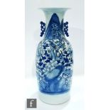 A 20th Century Chinese and white baluster vase, extending to a flared rim, the neck flanked by